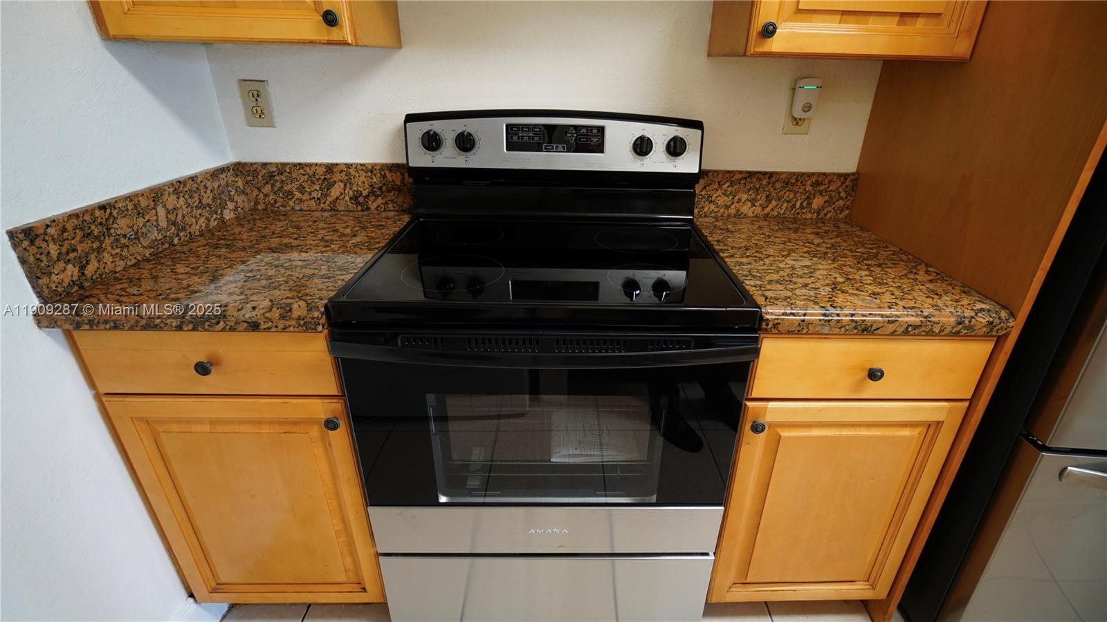 15231 Southwest 80th Street, Unit 101 Miami, FL 33193 - Photo 6 of 19 a stove top oven sitting inside of a kitchen