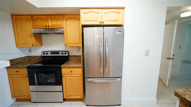 a kitchen with a refrigerator and a stove