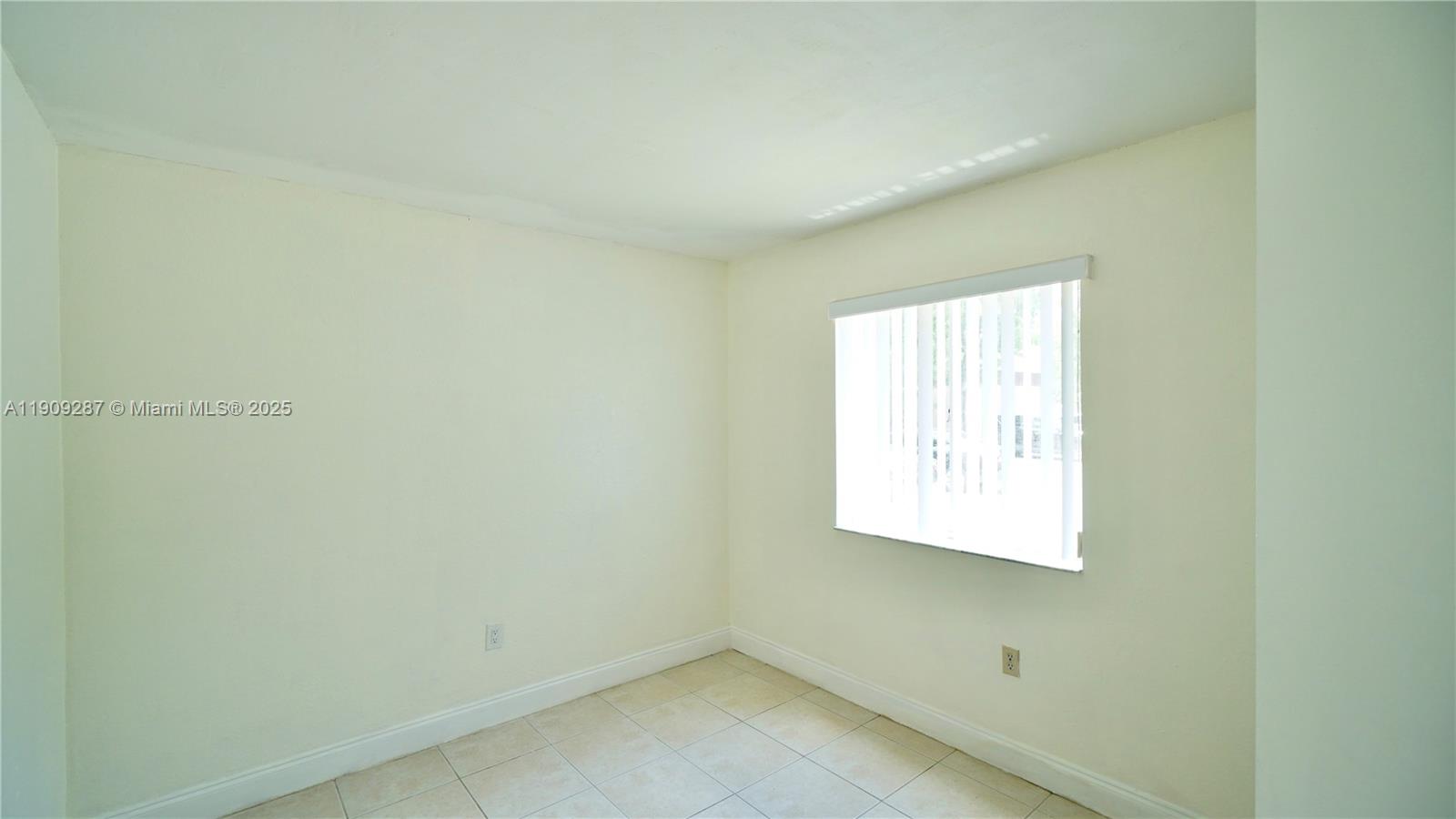 15231 Southwest 80th Street, Unit 101 Miami, FL 33193 - Photo 8 of 19 an empty room with a window
