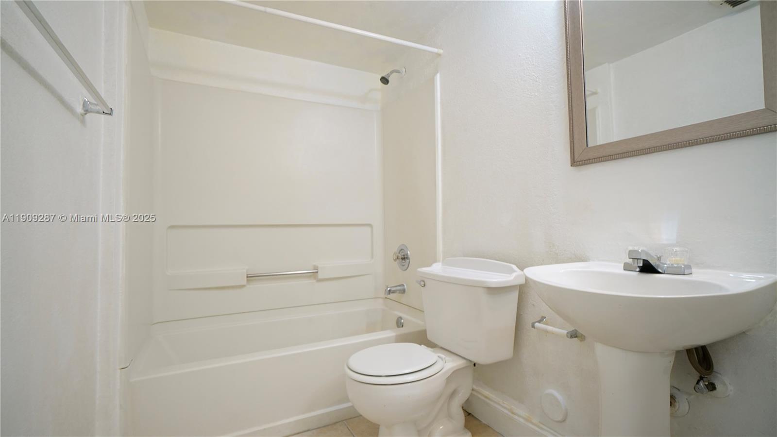 15231 Southwest 80th Street, Unit 101 Miami, FL 33193 - Photo 10 of 19 a bathroom with a sink a toilet and shower