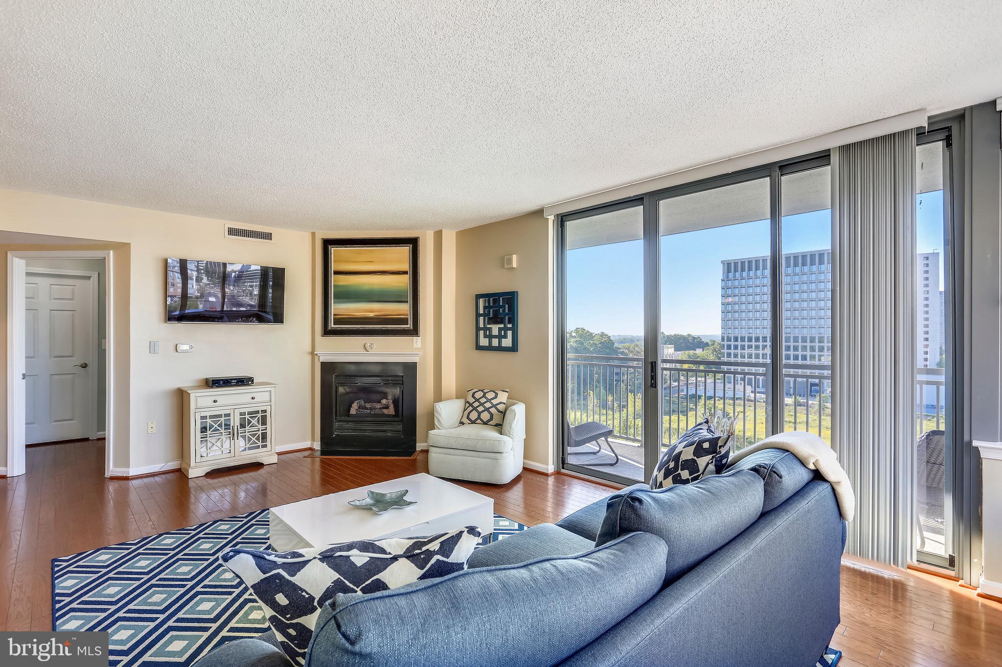 11710 Old Georgetown Road, Unit 901 North Bethesda, MD 20852 - Photo 10 of 32 gas fireplace & sliding glass door to the balcony
