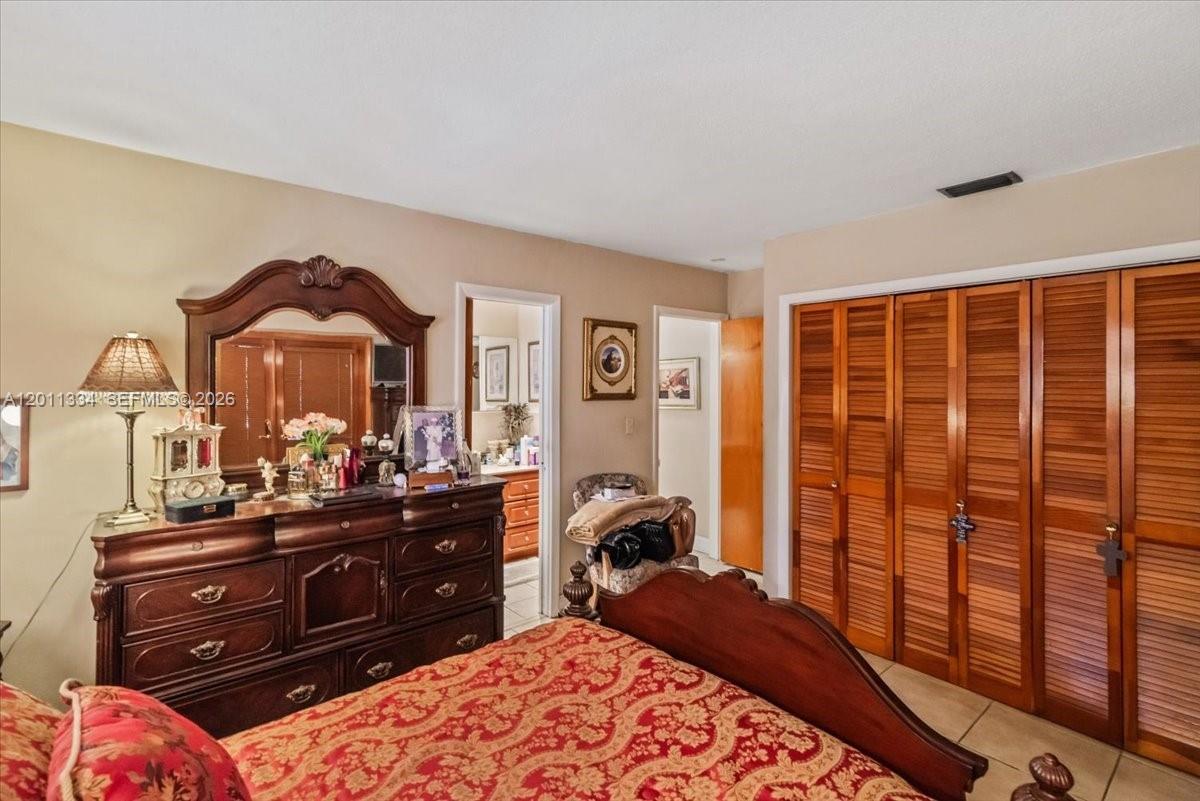 6385 Southwest 25th Street Miami, FL 33155 - Photo 11 of 28 a bedroom with a bed and a dresser