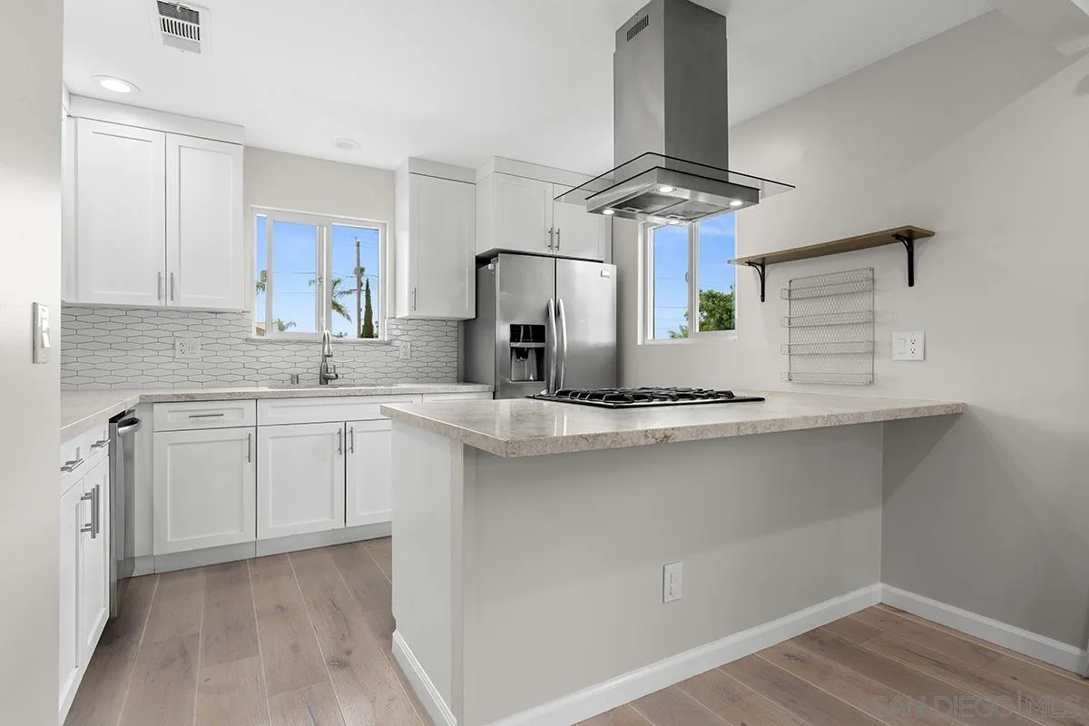 a kitchen with stainless steel appliances a sink stove and cabinets