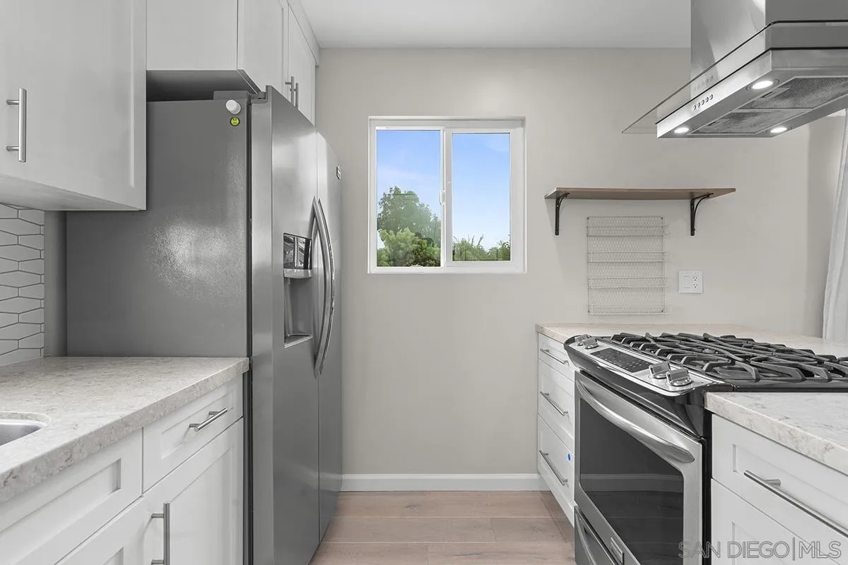 3539 Granada Avenue San Diego, CA 92104 - Photo 13 of 35 a kitchen with stainless steel appliances granite countertop a refrigerator and a stove