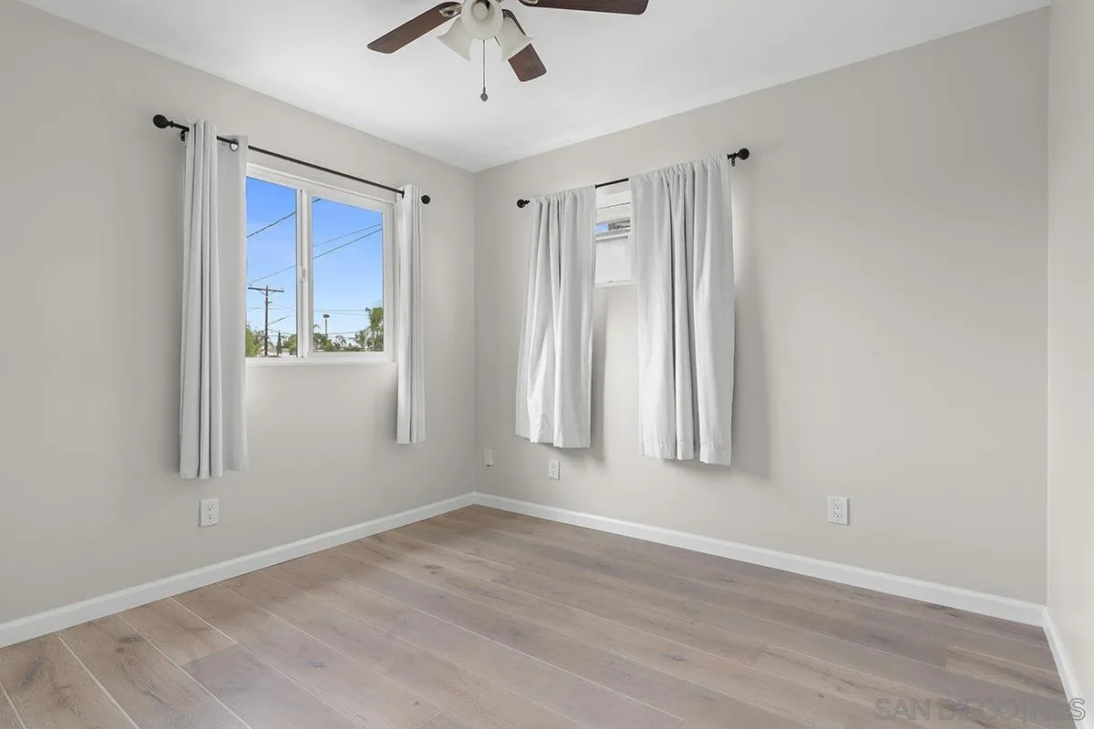3539 Granada Avenue San Diego, CA 92104 - Photo 19 of 35 an empty room with wooden floor closet and windows