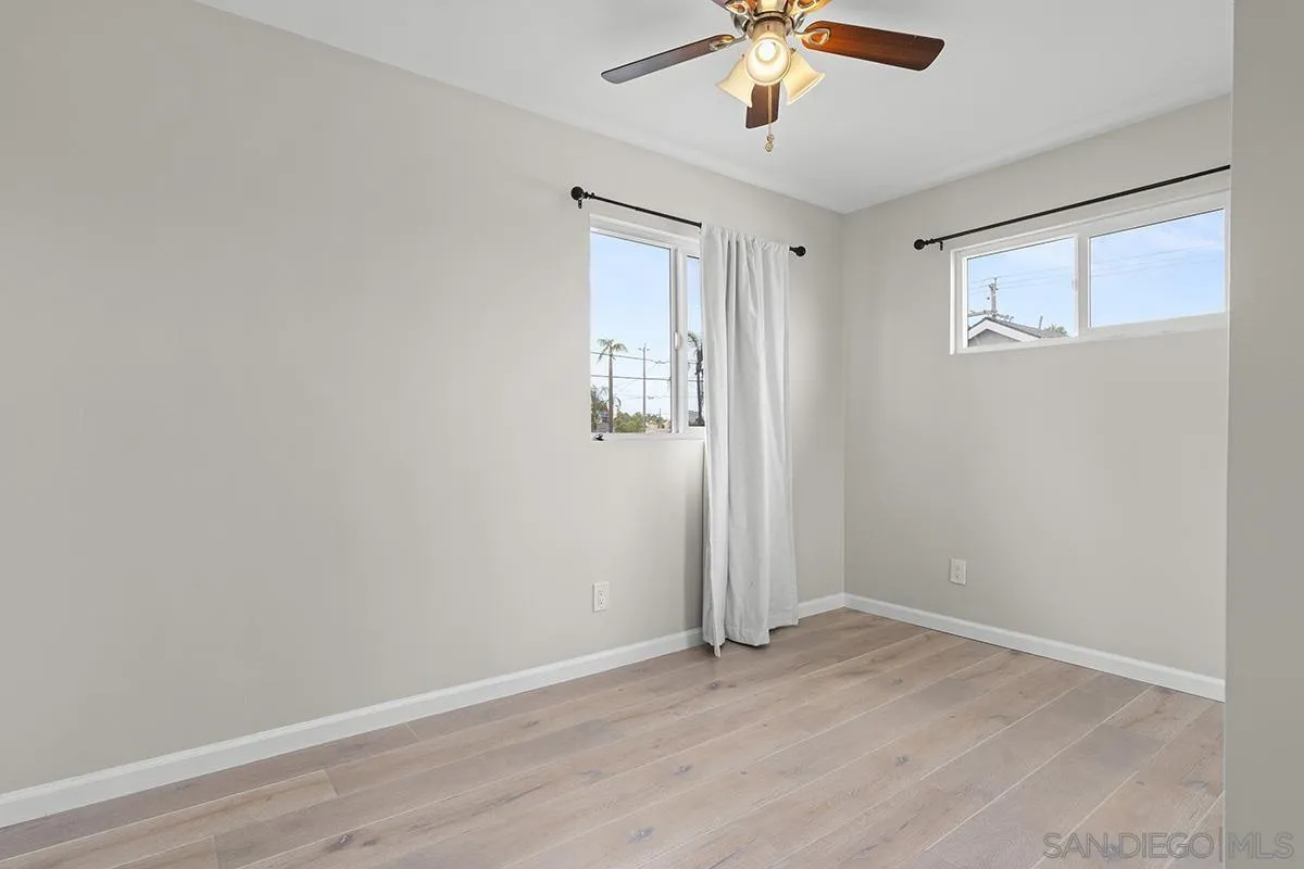 3539 Granada Avenue San Diego, CA 92104 - Photo 22 of 35 a view of an empty room with wooden floor and a window