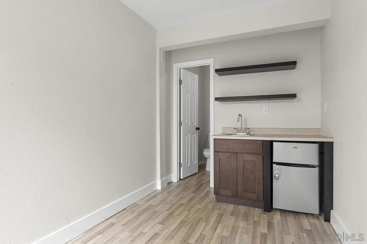 3539 Granada Avenue San Diego, CA 92104 - Photo 30 of 35 a room with a wooden floor and cabinets