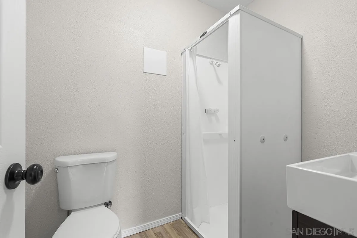 3539 Granada Avenue San Diego, CA 92104 - Photo 31 of 35 a white toilet sitting next to a shower