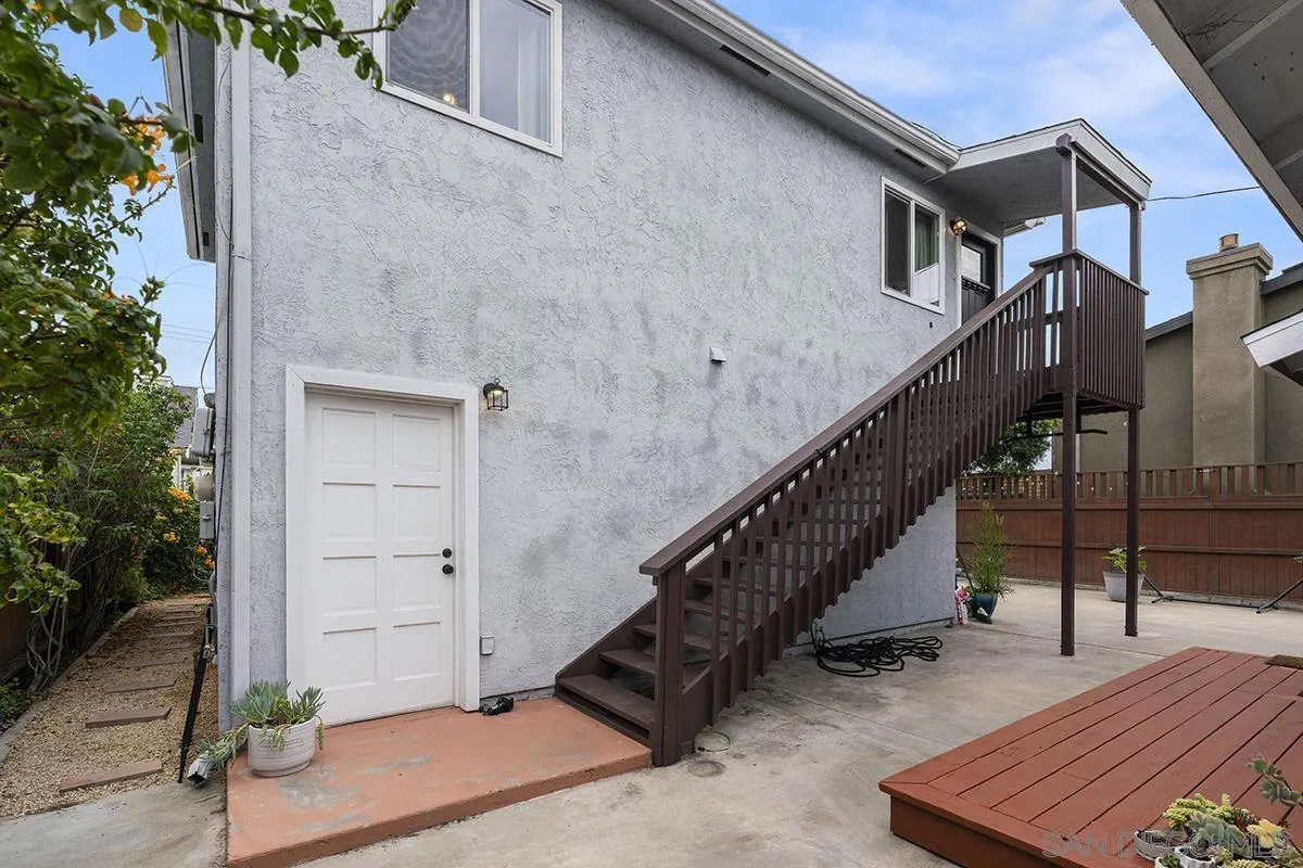 3539 Granada Avenue San Diego, CA 92104 - Photo 5 of 35 a view of a house with wooden stairs and a small yard