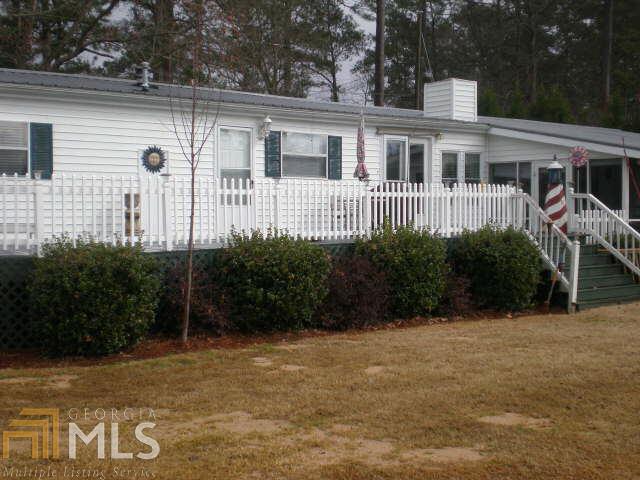 254 Scout Island Road Jackson, GA 30233 - Photo 1 of 1 a view of a house with backyard and garden