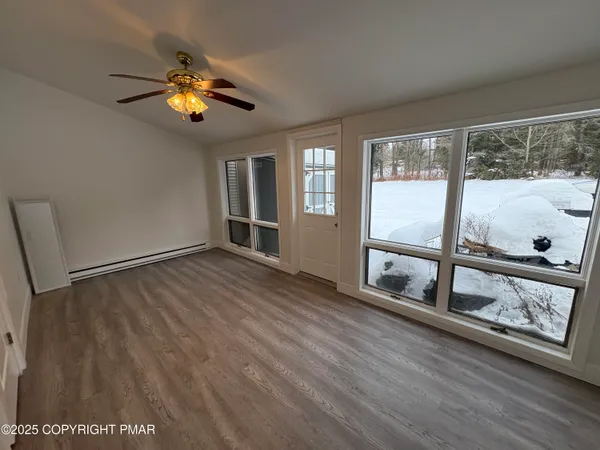 wooden floor in an empty room with a window