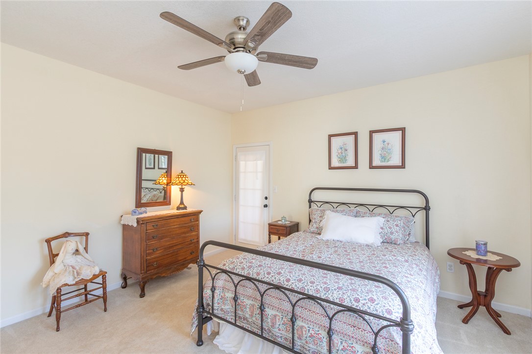 108 Pearman Drive Pendleton, SC 29670 - Photo 21 of 50 This cozy bedroom features a ceiling fan, plush carpet flooring, and convenient outdoor access.