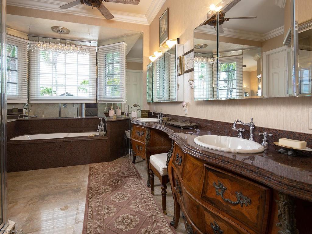 720 17th Avenue South Naples, FL 34102 - Photo 11 of 33 a bathroom with a granite countertop sink and a bathtub