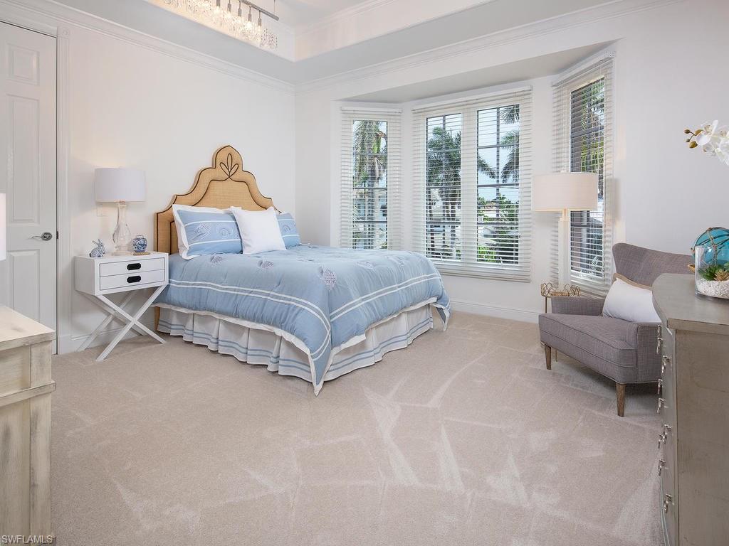 720 17th Avenue South Naples, FL 34102 - Photo 12 of 33 a bedroom with a bed and a couch