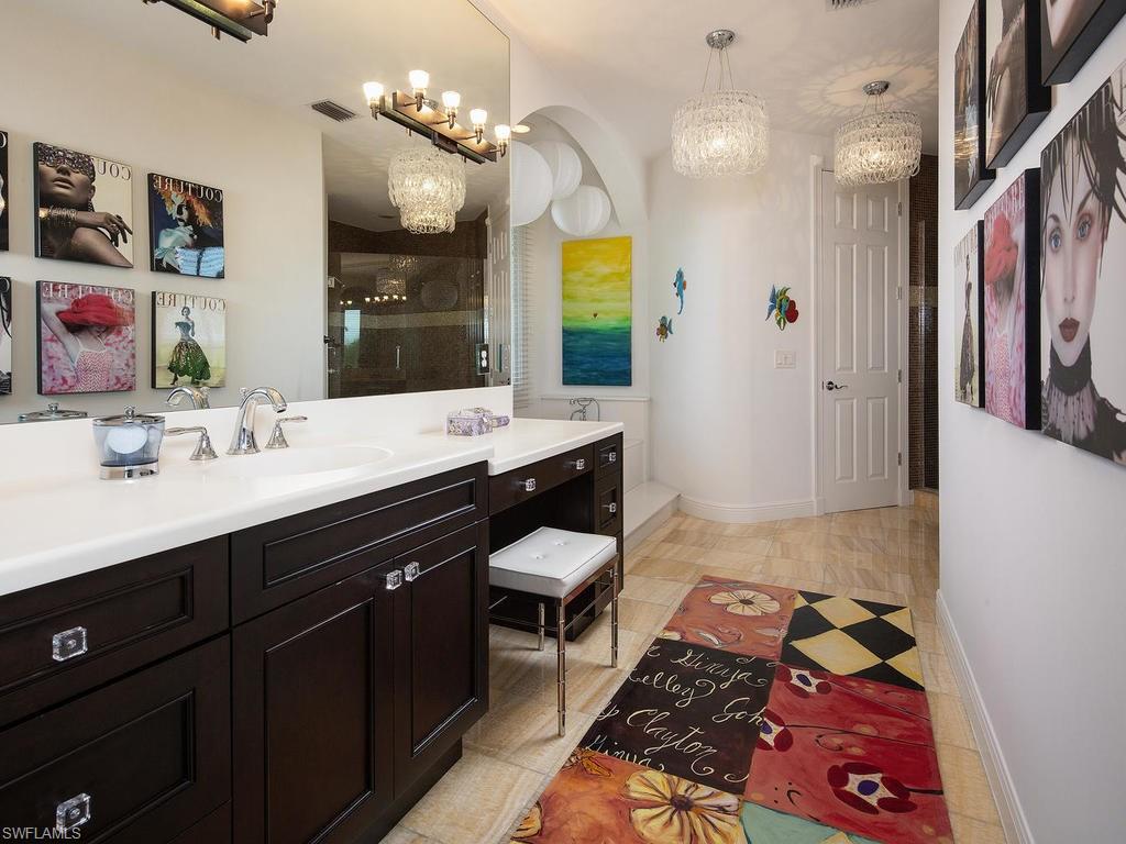720 17th Avenue South Naples, FL 34102 - Photo 17 of 33 a spacious bathroom with a double vanity sink a mirror and shower