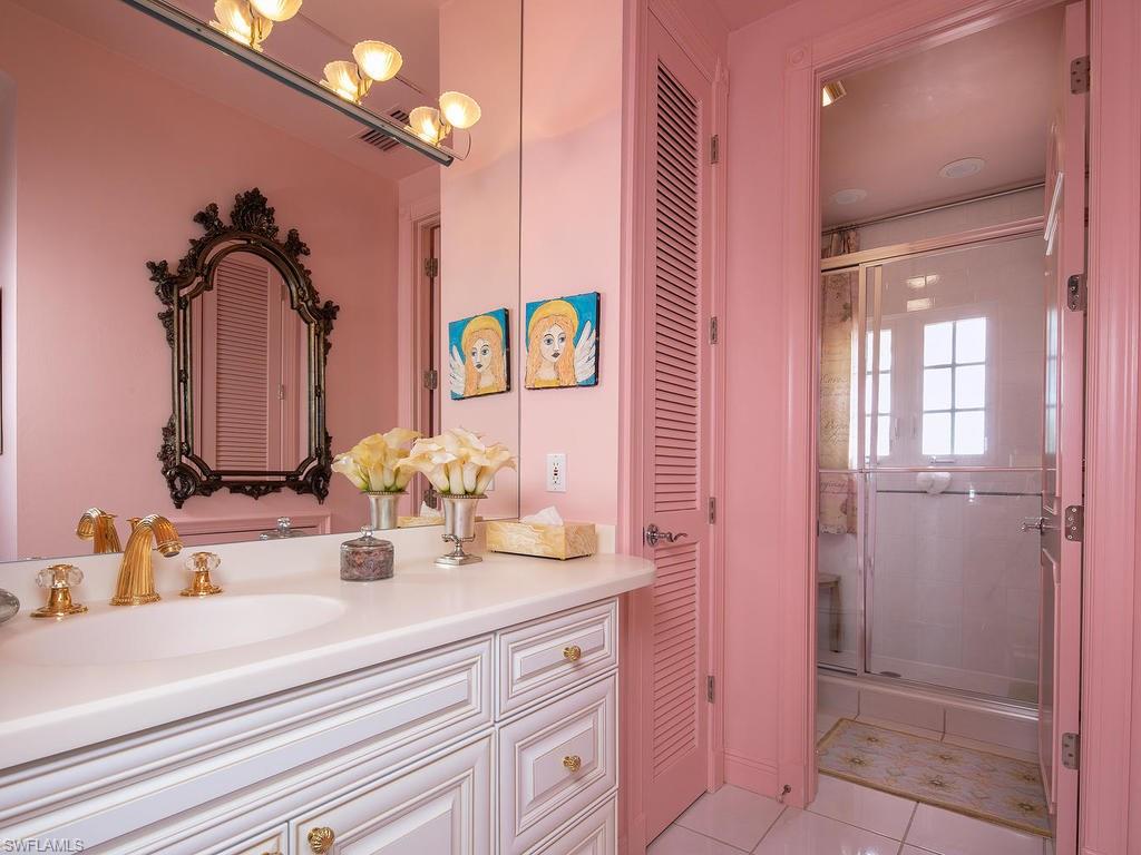 720 17th Avenue South Naples, FL 34102 - Photo 20 of 33 a bathroom with a sink vanity and mirror