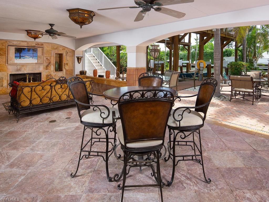 720 17th Avenue South Naples, FL 34102 - Photo 25 of 33 a view of a livingroom with furniture water view and a floor to ceiling window