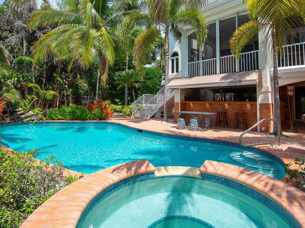 720 17th Avenue South Naples, FL 34102 - Photo 27 of 33 an outdoor view of house with swimming pool and yard