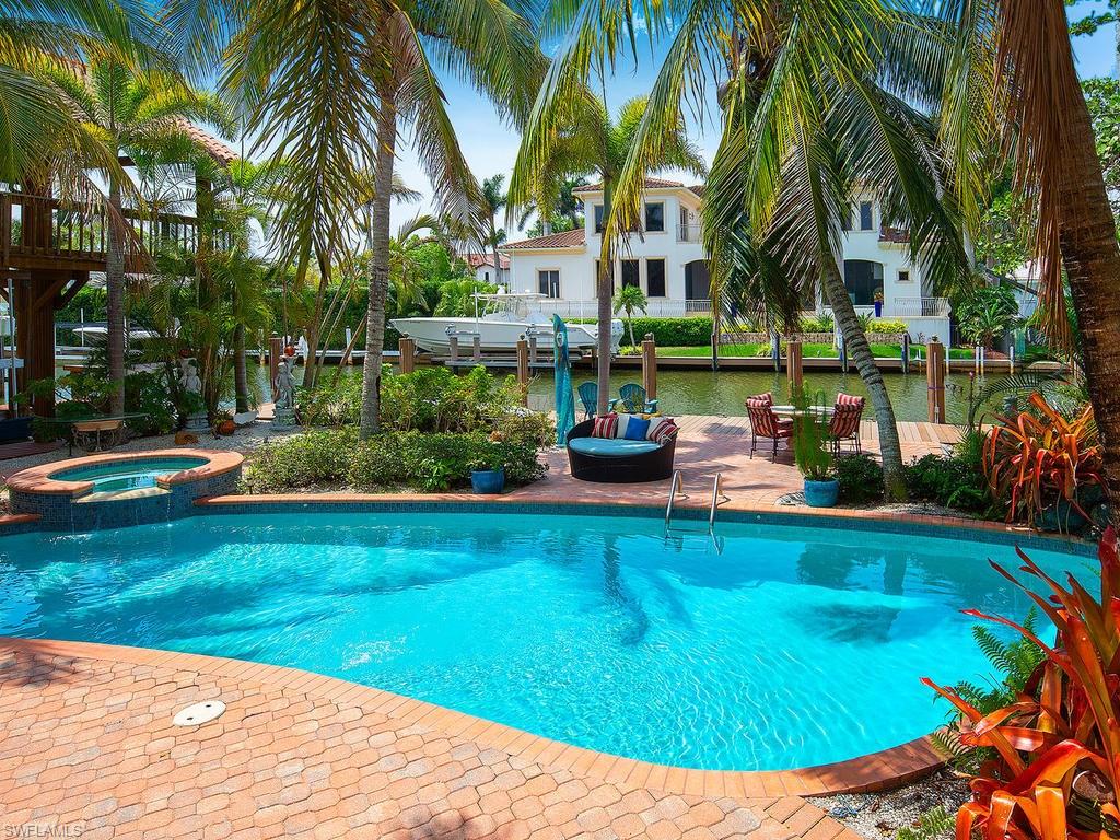720 17th Avenue South Naples, FL 34102 - Photo 28 of 33 a view of a swimming pool with a garden and plants