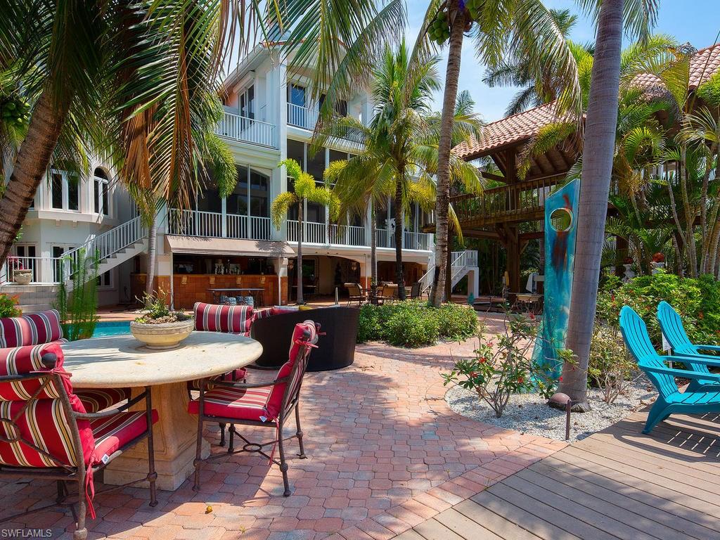 720 17th Avenue South Naples, FL 34102 - Photo 29 of 33 a view of a dinning table and chairs in a patio in a patio