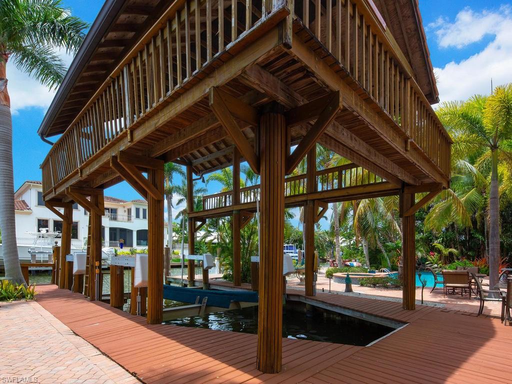 720 17th Avenue South Naples, FL 34102 - Photo 30 of 33 a view of a house with a deck and sitting area