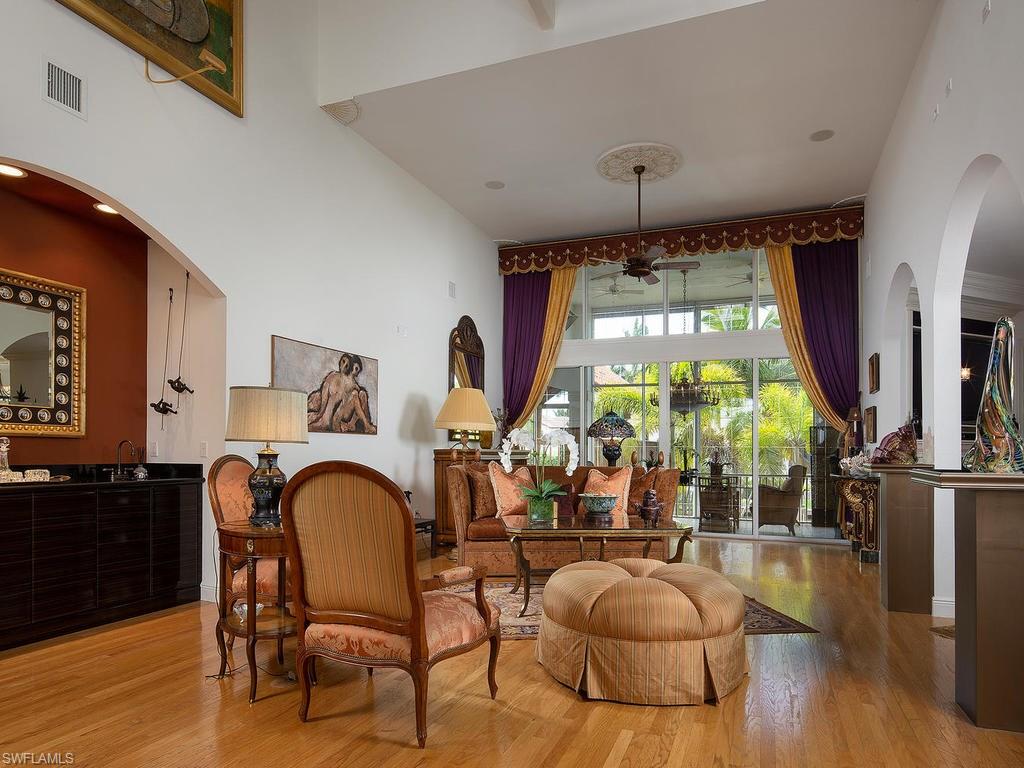 720 17th Avenue South Naples, FL 34102 - Photo 3 of 33 a living room with fireplace furniture and a large window