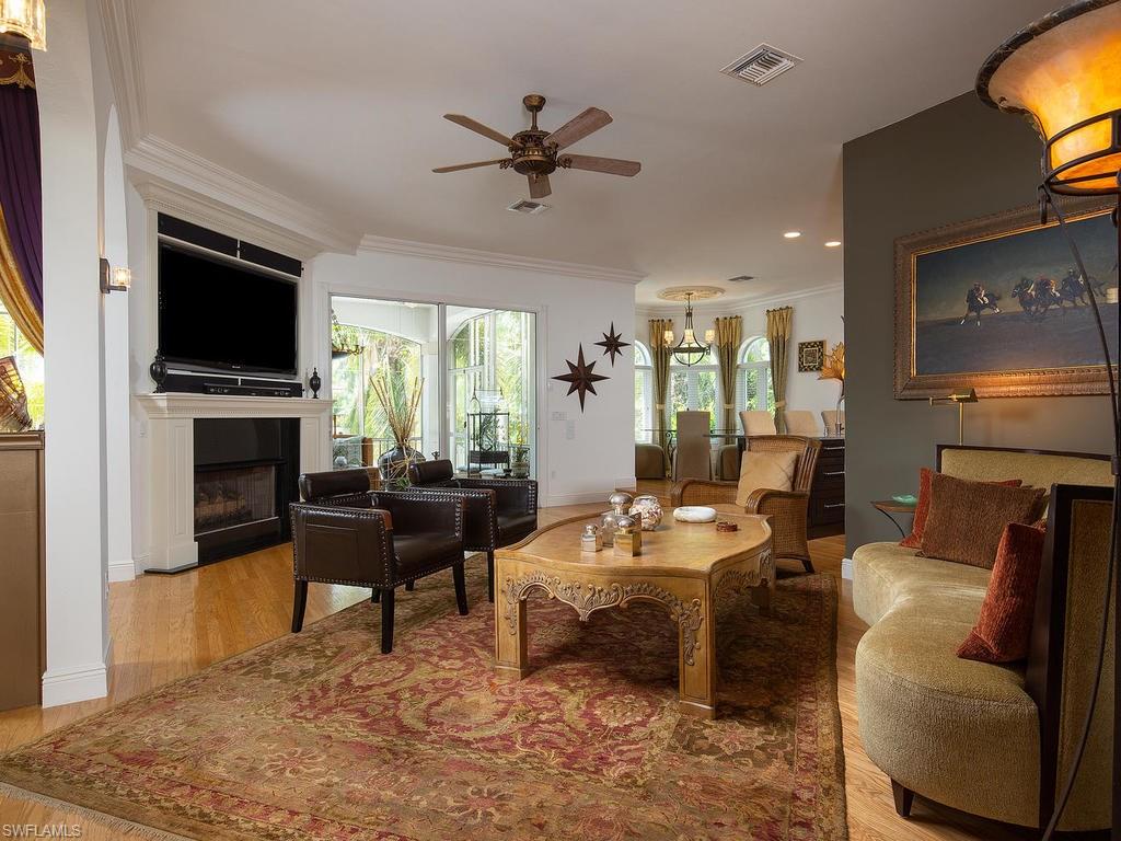 720 17th Avenue South Naples, FL 34102 - Photo 4 of 33 a living room with furniture a fireplace and a flat screen tv