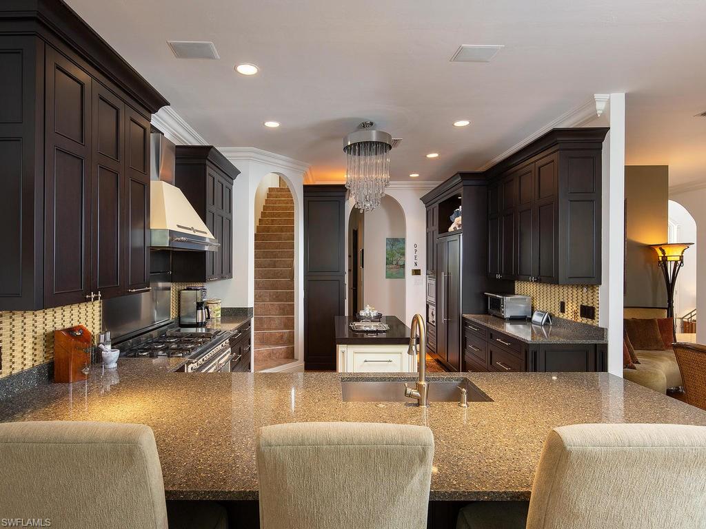 720 17th Avenue South Naples, FL 34102 - Photo 6 of 33 a living room with furniture and a flat screen tv