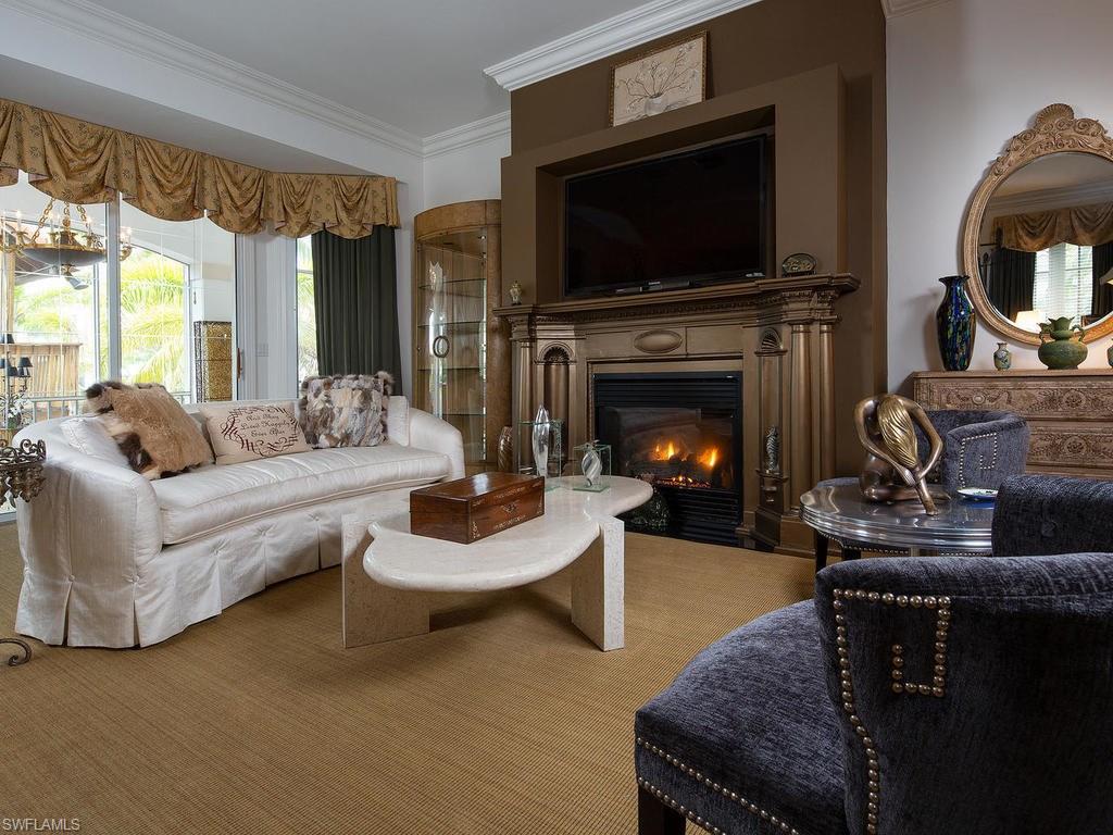 720 17th Avenue South Naples, FL 34102 - Photo 10 of 33 a living room with furniture a flat screen tv and a fireplace