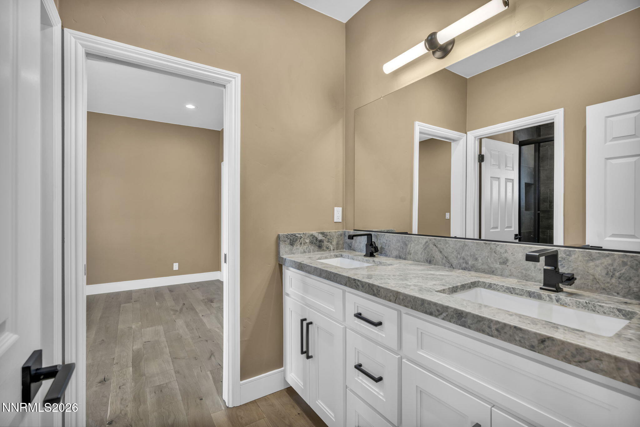 2965 Roundrock Court Reno, NV 89511 - Photo 25 of 40 a bathroom with a granite countertop sink and a mirror
