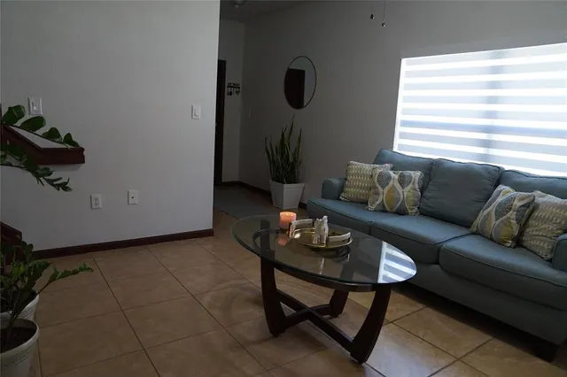 a view of a livingroom with furniture and hallway