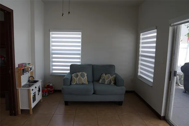 a front view of a house with a garden and plants