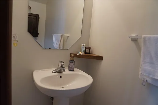 a bathroom with a sink and mirror