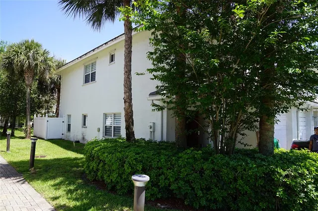 a view of a house with a small yard and plants