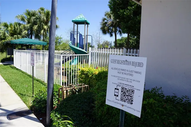 a view of a sign in a yard with potted plants