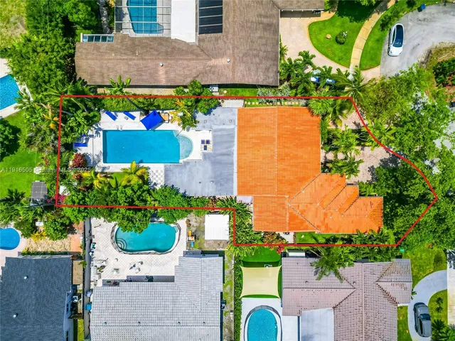 an aerial view of a house with a yard and a garden
