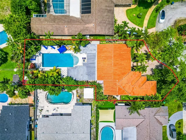 an aerial view of a house with a yard and garden
