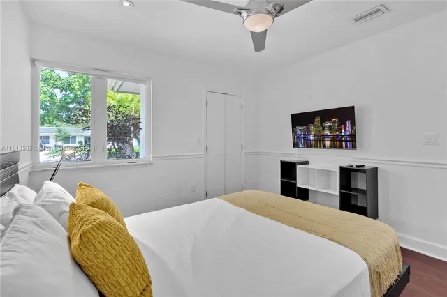 a bedroom with two beds and a desk