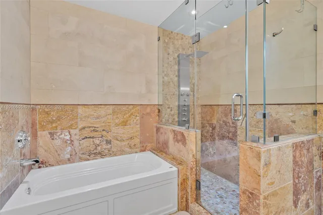 a bathroom with a bathtub shower sink and toilet