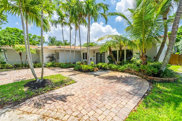 a view of a palm trees in front of a house