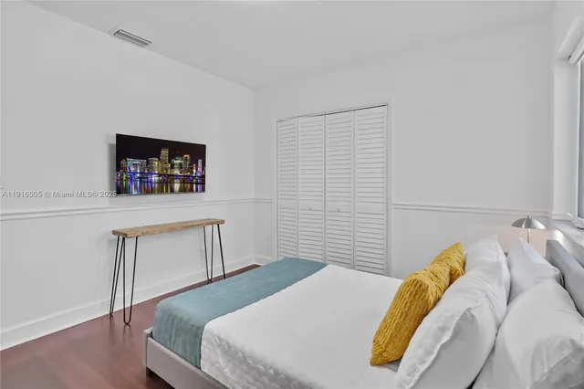 a bathroom with a sink mirror vanity and toilet
