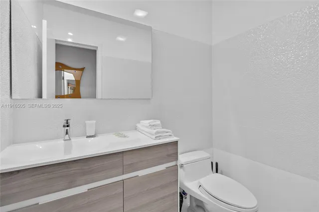 a bedroom with bed and wooden floor