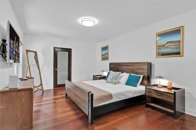 a bedroom with a bed and a flat screen tv