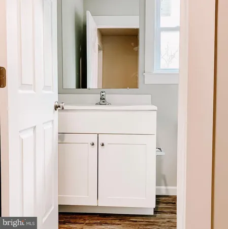 a bathroom with a toilet a sink and a window