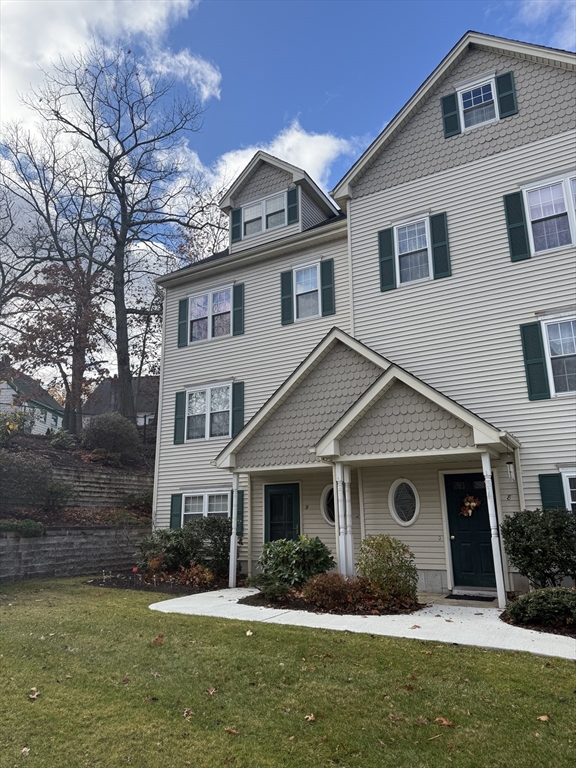 67 North Quinsigamond Avenue, Unit 9 Shrewsbury, MA 01545 - Photo 1 of 14 a front view of a house with a yard and garage