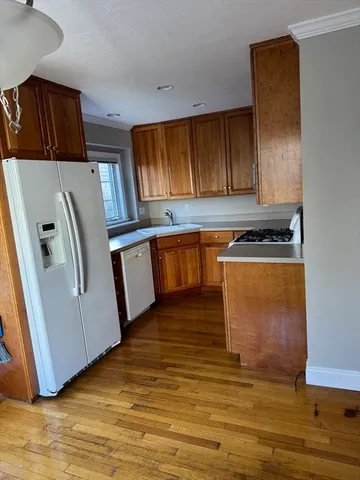a view of empty room with window and wooden floor