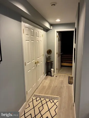 a large white bed sitting in a bedroom next to a window