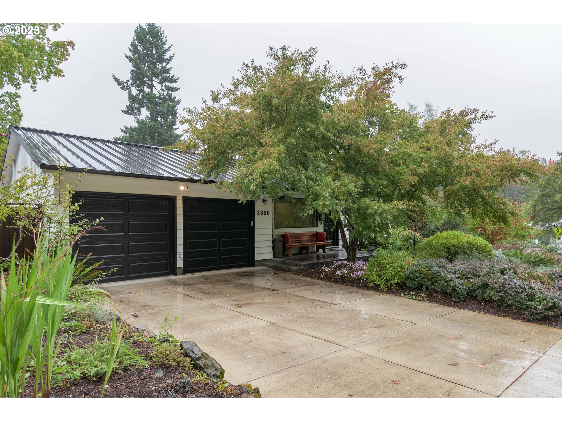 a backyard of a house with barbeque oven and outdoor seating
