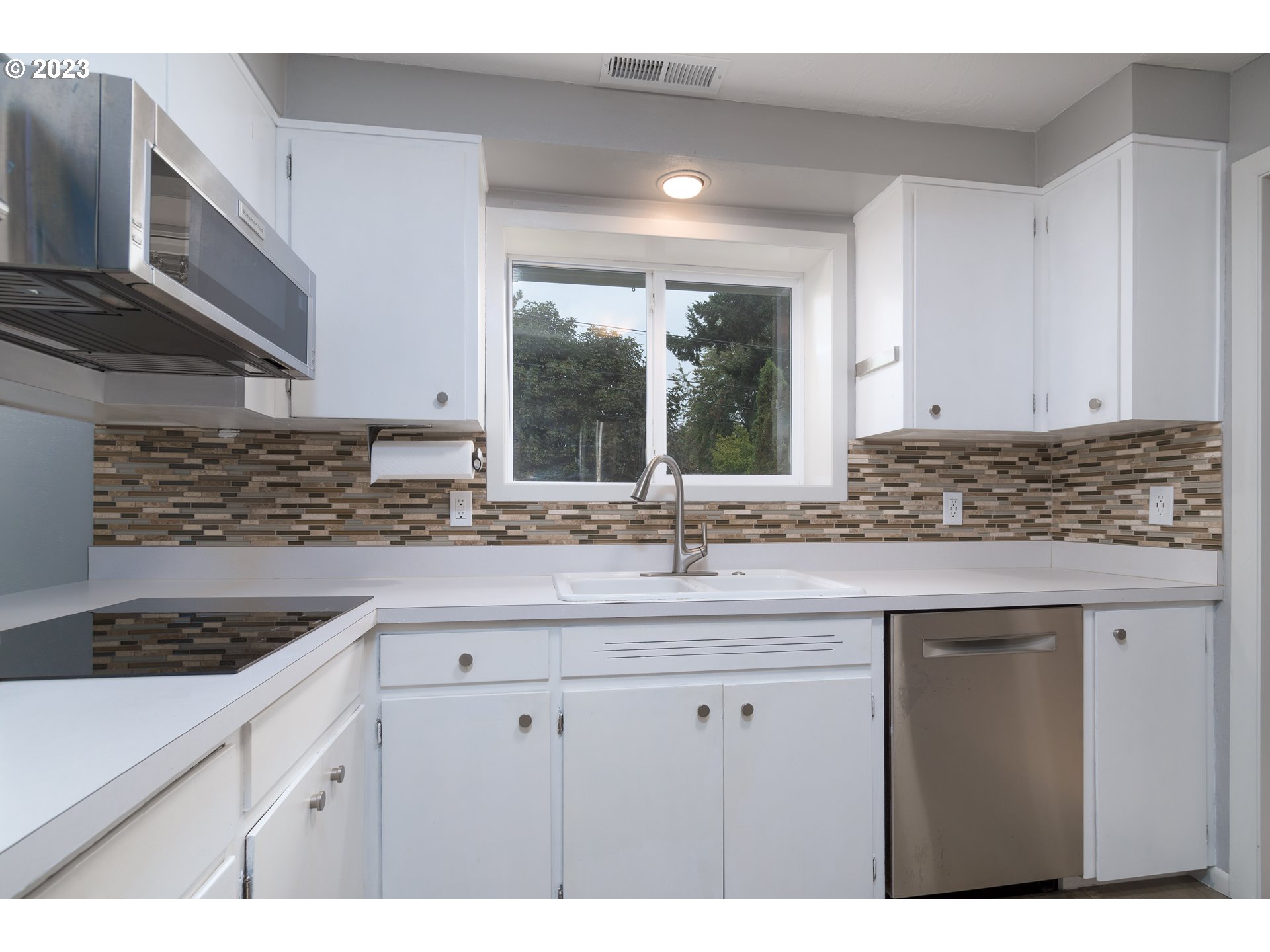 3950 Donald Street Eugene, OR 97405 - Photo 14 of 33 a kitchen with stainless steel appliances granite countertop a sink stove and cabinets
