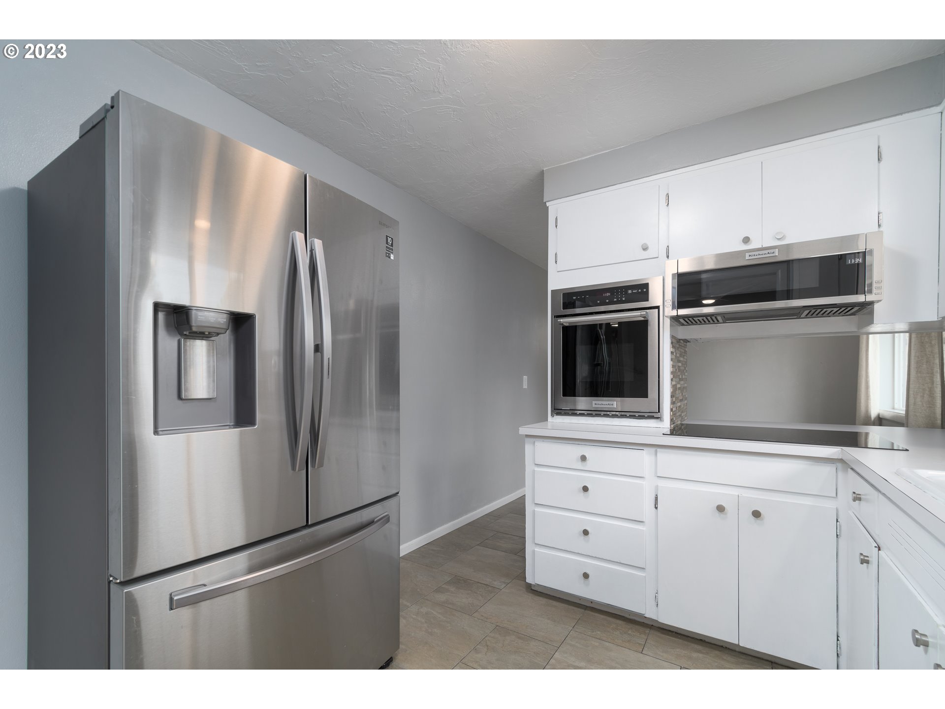 3950 Donald Street Eugene, OR 97405 - Photo 16 of 33 a kitchen with stainless steel appliances a refrigerator and cabinets